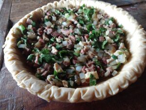 Chicken and beef pie with horseradish greens.