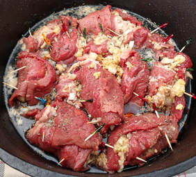 Rolls of stuffed beef in ale sauce