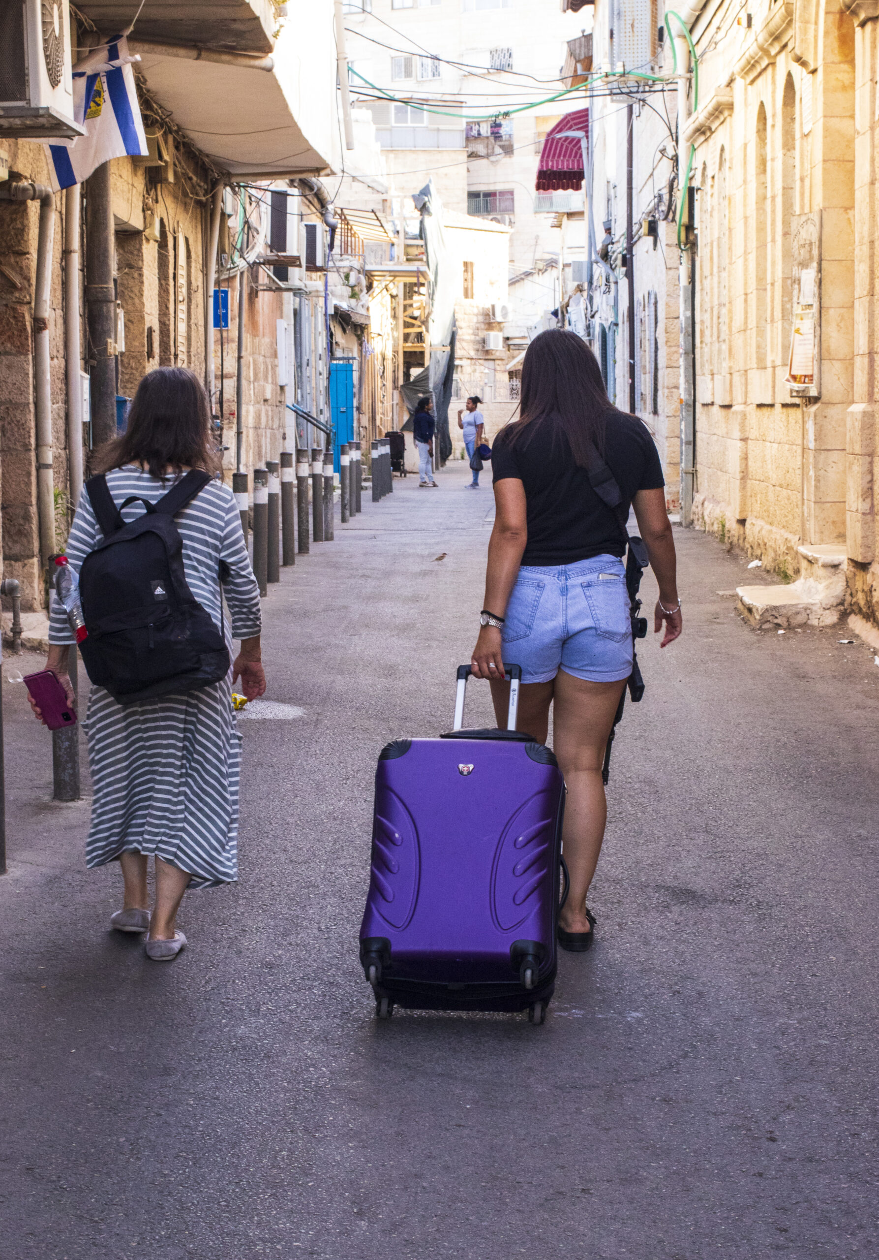 An off duty soldier moves through the Jerusalem Nachlaot neighbourhood early in the morning. In peacetime, when security isn't heightened, you would only usually see out of uniform individuals carrying their weapon while travelling between home and base.