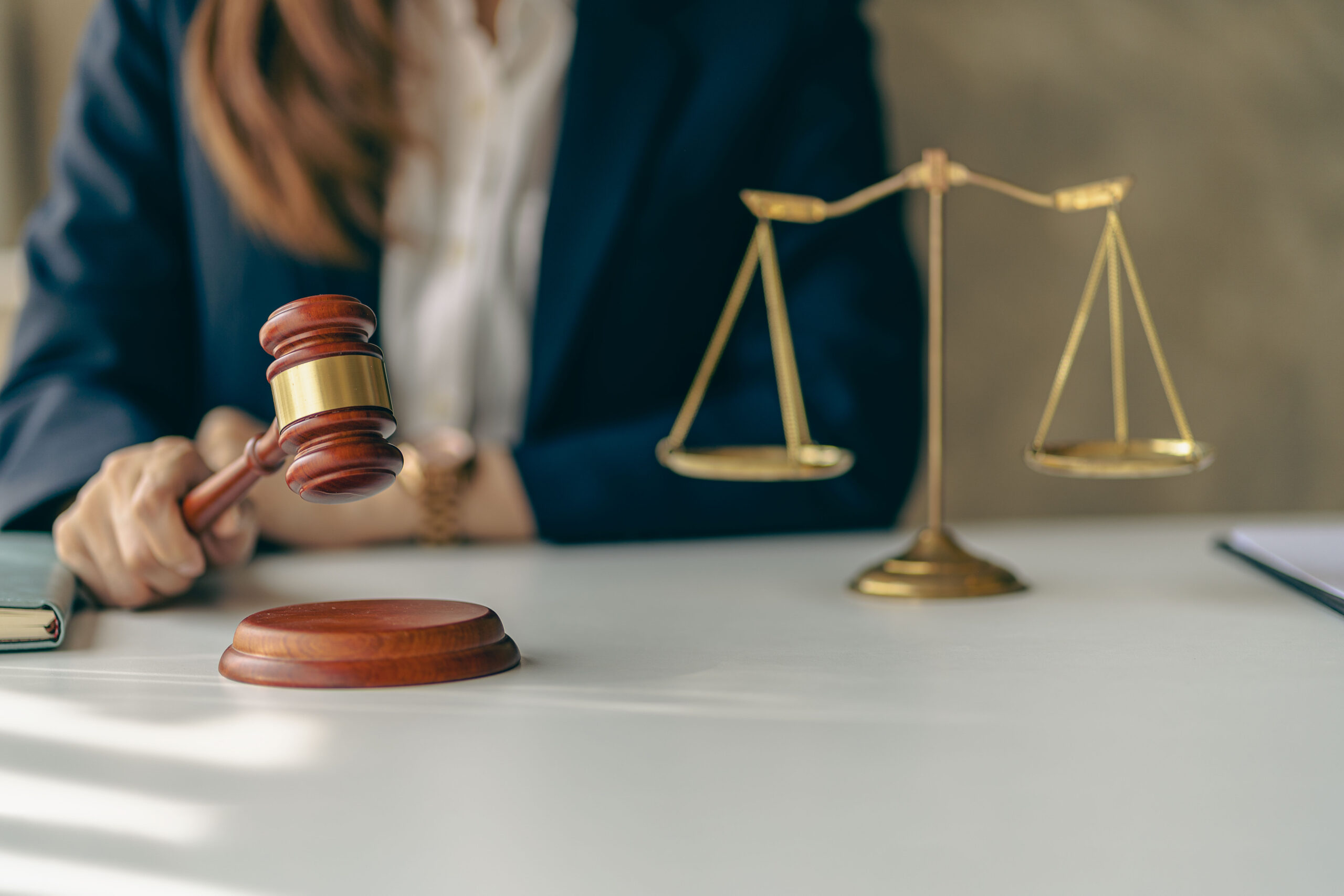 Lawyer challenging business woman in suit or lawyer working on documents Legal advice and justice Female lawyer working at law firm and squatting with court scales