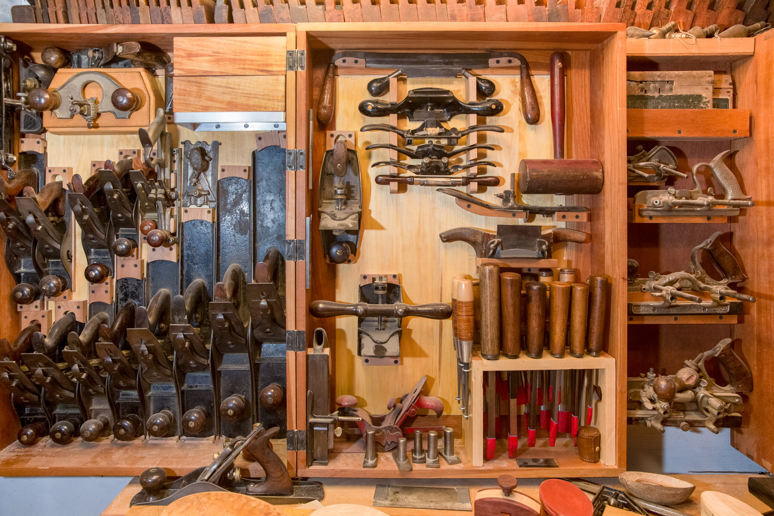 Collection of antique woodworking tools in a wooden chest.    Lots of texture and warmth with a vintage subject and look.