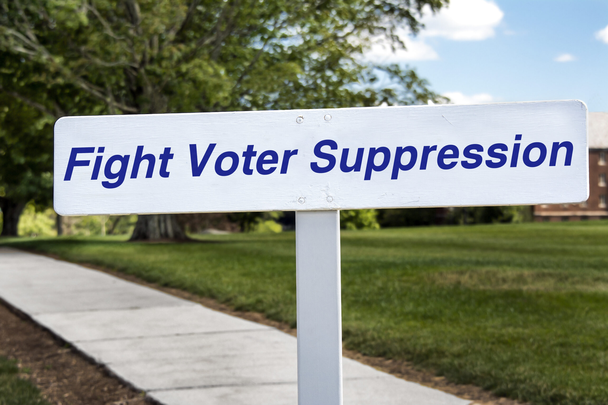 Photo illustration of a sign encouraging acting to stop voter suppression or activities that block voting.